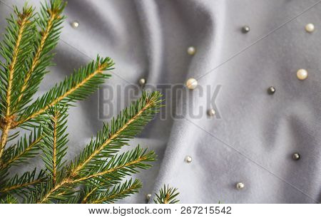 Green Branches Of Spruce With A Cozy Warm Knitted Scarf, Place For Text. Rustic Christmas Tree And W