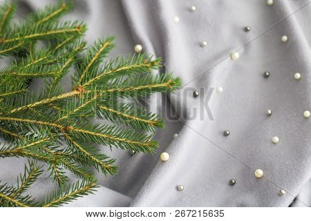 Green Branches Of Spruce With A Cozy Warm Knitted Scarf, Place For Text. Rustic Christmas Tree And W