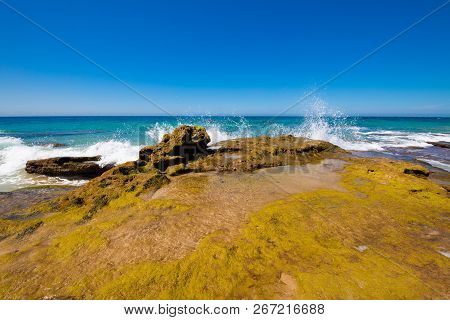 Ocean Wave Breaking On Rocky Coast In Cadiz