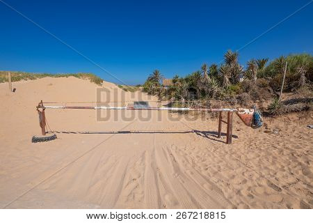 White And Red Old Metal Barrier Closed On Sand Track In Trafalgar Cape, Canos Meca Village (barbarte