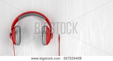 Red Over-ear Headphones With 3.5mm Headphone Connector On Wood Background, 3d Illustration