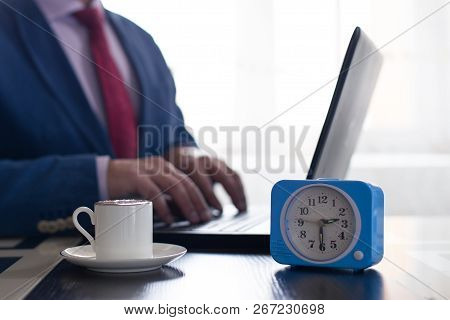 Businessman Completes Work On The Laptop And Plans To Drink Coffee. The Concept Of Rest And Time Man