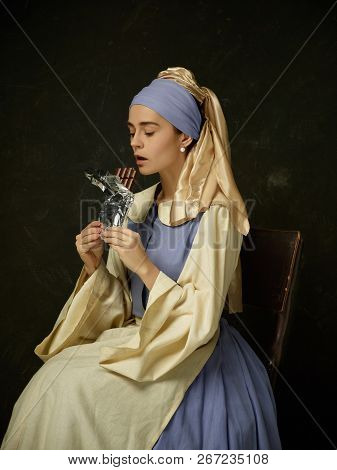 Medieval Woman In Historical Costume Wearing Corset Dress And Bonnet. Beautiful Peasant Girl Wearing