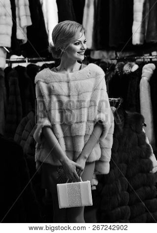 Lady Holds White Bag In Fur Shop. Winter Clothing Concept.