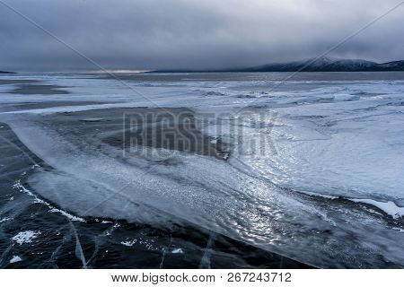 Lake Khubsugul Is Covered With Ice And Snow, Strong Cold, Thick Clear Blue Ice. Lake Khubsugul Is A 