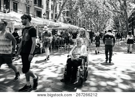 Barcelona, Spain - Jun 1, 2018: Locals And Tourists In Central Barcelona Walking On The Iconic Rambl