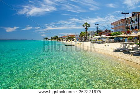 Sandy Beach With Blue Paradise Water Of Toroneos Kolpos Gulf, Blue Sky, White Clouds In Pefkohori, H