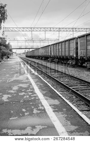 View Of Empty Railway Platform And Freight Train.