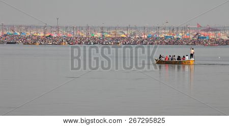 ALLAHABAD, INDIA - FEBRUARY 12, 2013: Thousands of Hindu devotees come to confluence of the Ganges and Yamuna River for holy dip during the festival Kumbh Mela. The world's largest religious gathering