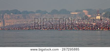 ALLAHABAD, INDIA - FEBRUARY 12, 2013: Thousands of Hindu devotees come to confluence of the Ganges and Yamuna River for holy dip during the festival Kumbh Mela. The world's largest religious gathering