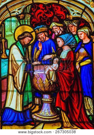 Bayeux, France - February 12, 1013: Stained Glass Depicting A Catholic Baptism In The Cathedral Of B