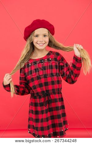 Kid Little Cute Girl With Long Hair Posing In Hat Red Background. How To Wear French Beret. Beret St