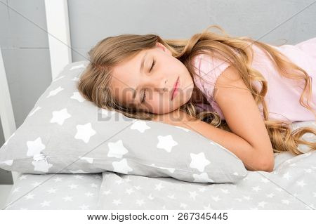Healthy Sleep Tips. Girl Sleep On Little Pillow Bedclothes Background. Kid Long Curly Hair Fall Asle