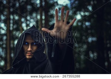 The Black Monk Pointing His Finger In The Woods