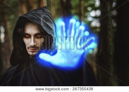 The Black Monk Pointing His Finger In The Woods