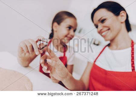 Mom And Girl Cook Cake. Apron For Two Girls. Lettle Girl With Mom Bake A Cake With Sugar. Love And H