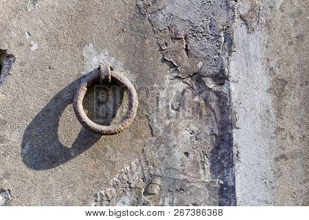 Old Iron Hoop Hanging From Stone Wall