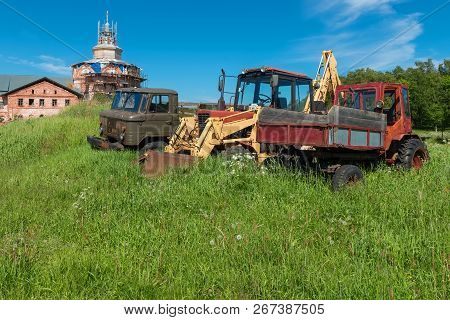 Cars And A Tractor At The Trinity Skete On Anzersky Island, Solovetsky Islands, Arkhangelsk Region, 