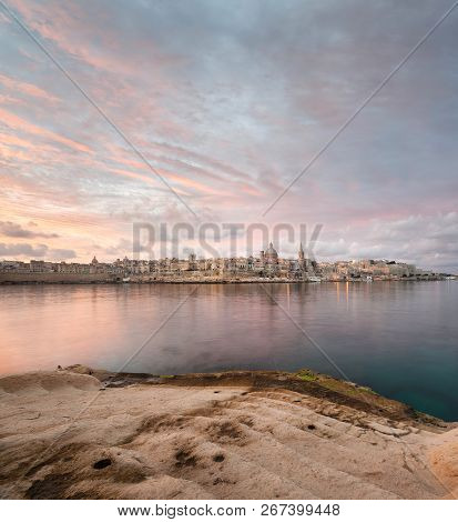 Dramatic Sunrise Over Il-belt Valletta, Carmelite Church In Malta. View From The Sliema Shore. High 