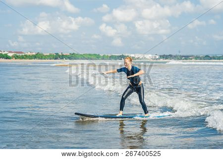 Joyful Young Woman Beginner Surfer With Blue Surf Has Fun On Small Sea Waves. Active Family Lifestyl