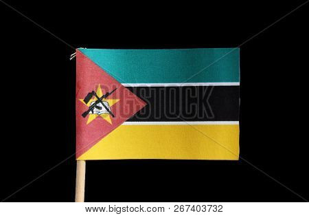 A National Flag Of Mozambique On Toothpick On Black Background. Consists Of Horizontal Tricolour Of 