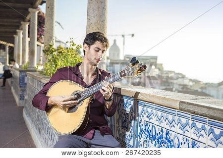 Fado Musician Playing On Portuguese Guitar In Lisbon, Portugal