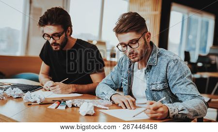 Two Talanted Artist Freelancer Drawing Indoors. Portrait Of Painters Sitting At Table Focused On Art