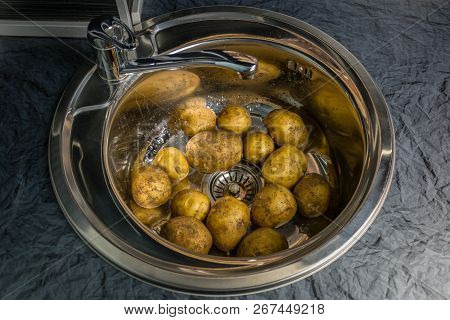Wash The Raw Potatoes In The Sink. Symbolizes Rural Home Cooking And Garden. Healthy Food Lifestyle.