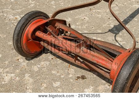 A Close Up View Look At A Reel Lawnmower Before The Paint Was Removed