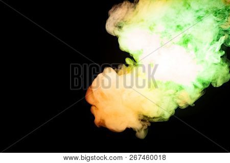 Multicolored Smoke Of Red Yellow And Green Colors From A Vap Scattering On A Black Isolated Backgrou