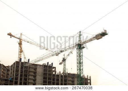 Construction Site Background. Hoisting Cranes And New Multi-storey Buildings. Copy Space For Text. N