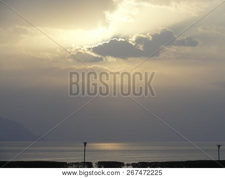 Seascape - Sunset, The Sun Sets In The Formidable Storm Clouds Over The Sea. Brutal, Anxious Colors 
