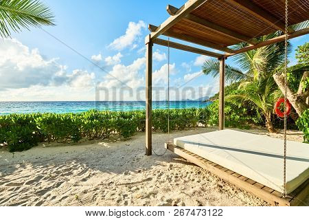 Luxury Wooden Lounge Beds On A Beautiful Mahe Beach, Seychelles