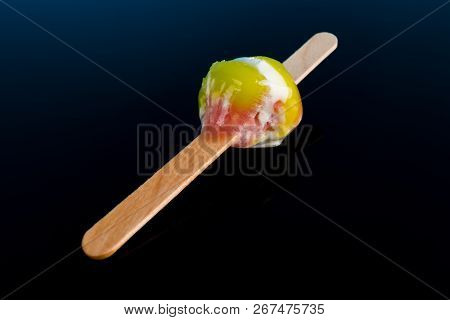 Multi Color Popsicle With The Last Bit On A Black Background