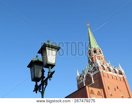Moscow Kremlin Tower And Vintage Lantern Isolated On Blue Sky Background. Troitskaya Tower With Red 