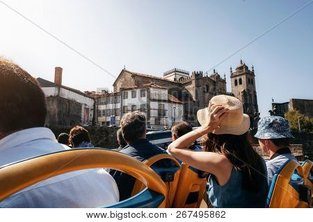Porto, Portugal. Tourists On Open Top Sightseeing Bus Hop On Hop Off In Explore City. Cathedral Seu 