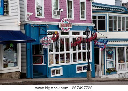 BAR HARBOR, MAINE, USA - AUGUST 9, 2010. Famouse Geddy`s Pub early morning in downtown Bar Harbor with empty sidewalk and store sign  without tourist.