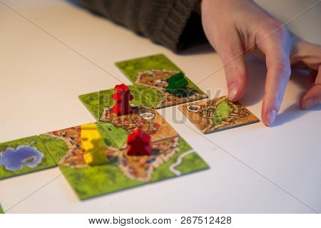 Basel, Switzerland - February 05, 2017: Close Up Of The Popular Board Game Carcassonne And A Hand Pu