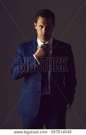 Successful Man, Confident Businessman Or Handsome Boss Adjusting Tie In Stylish Blue Formal Suit And