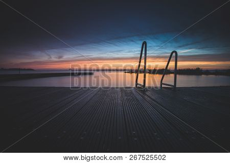 Architecture Outdoor Swimming Pool At The Lake With Metal Aluminum Swimming Stairs During An Impress