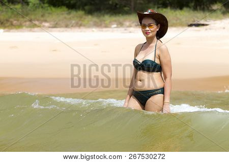 Woman Shape Sexy Enjoy With Bikini Hat And Wave On Beach At Bang Beot Beach, Chumphon Province Thail