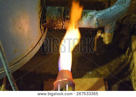Heating A Steel Pipe With A Blowtorch. The Flame Of A Blowtorch.