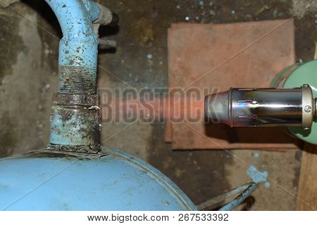 Heating A Steel Pipe With A Blowtorch. The Flame Of A Blowtorch.