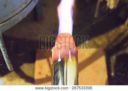 Heating A Steel Pipe With A Blowtorch. The Flame Of A Blowtorch.