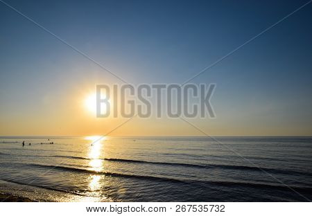 Sea Sunset. People Bathe In The Evening At Sunset In The Sea