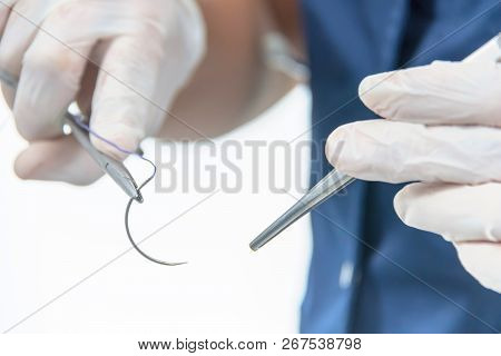 Doctor Holding Surgical Forceps Suture Needle, Suturing Material