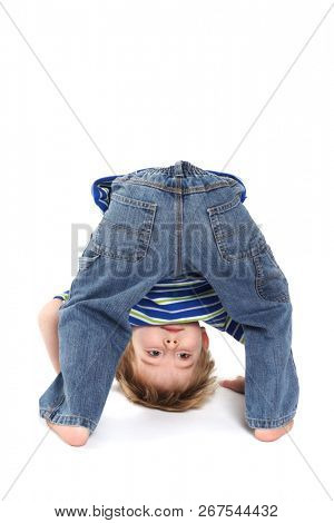 Young boy bending over and looking through his legs