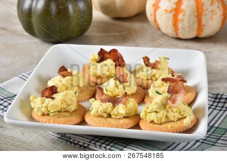 Crackers Topped With Deviled Egg And Bacon Bits
