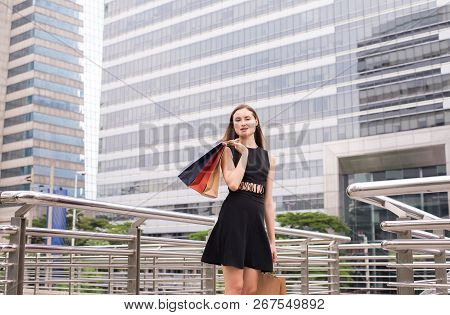 Portrait Of Beautiful Woman Smling And Holding Shopping Bags In City,lifestyle Concept