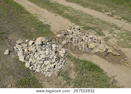 Road Patching. Pits On The Road Are Covered With Stones.
